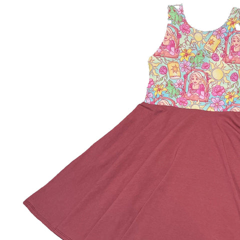 Children's dress with a colorful floral top and maroon skirt on a white background